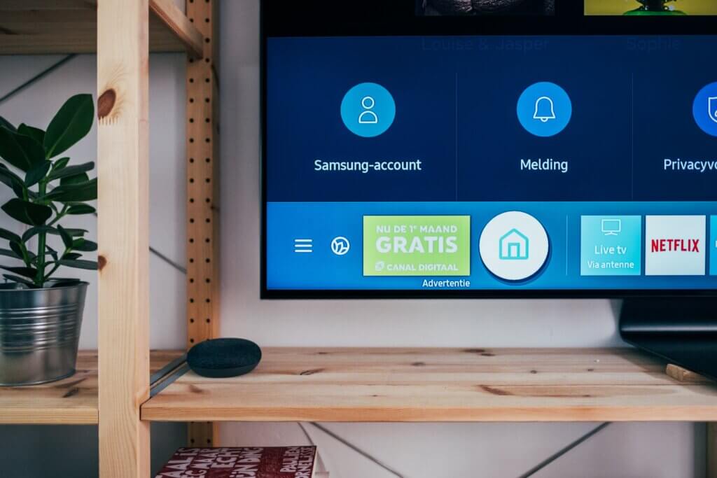 TV, open to its menu screen, on a wooden shelf