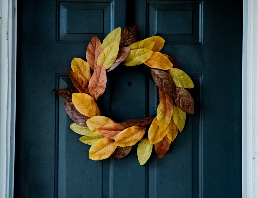 orange and yellow wreath on a cobalt door