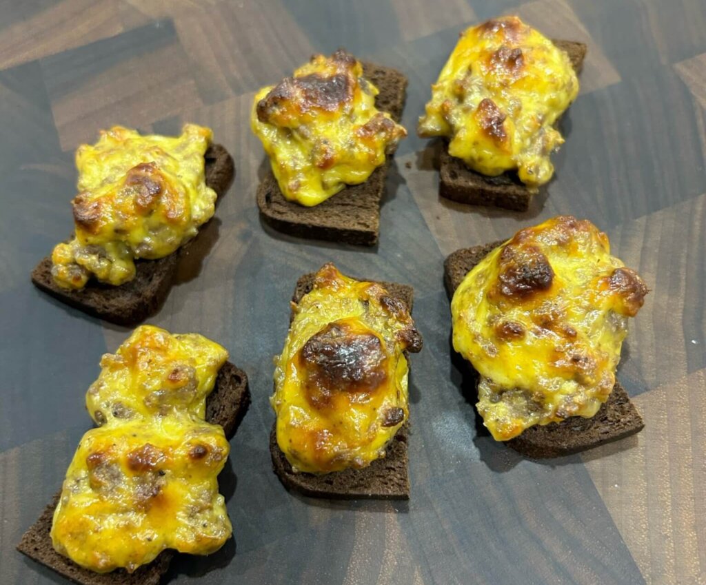 Egg mixture on slices of pumpernickel bread