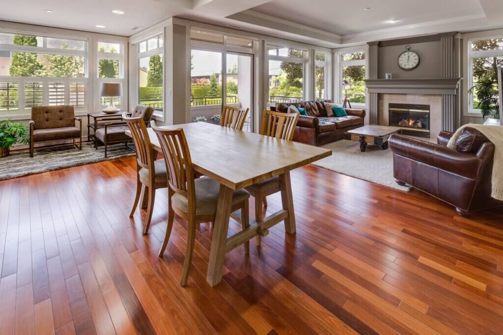 Open dining and living rooms with wood flooring