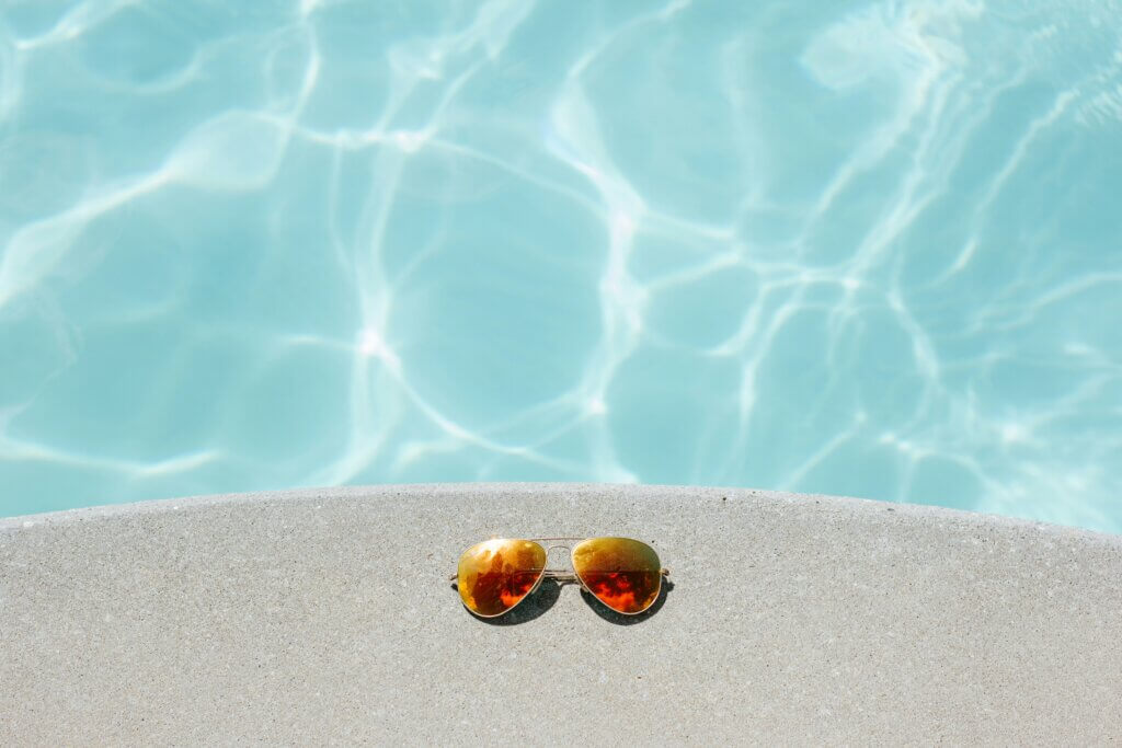 sunglasses by the edge of a pool