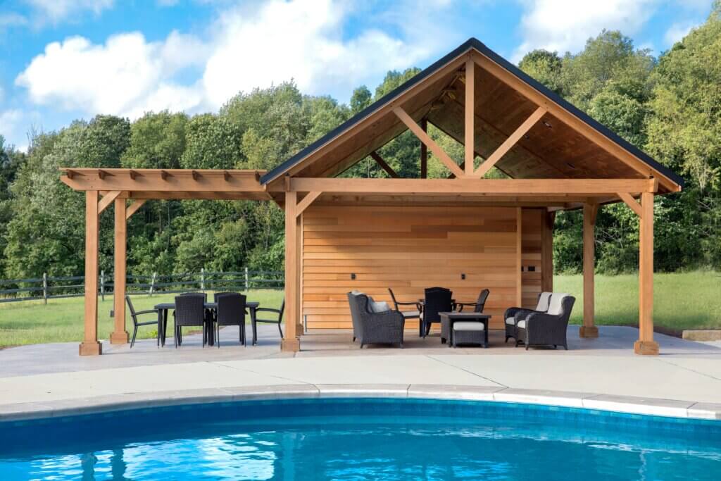 In-ground pool with a pool house and pergola