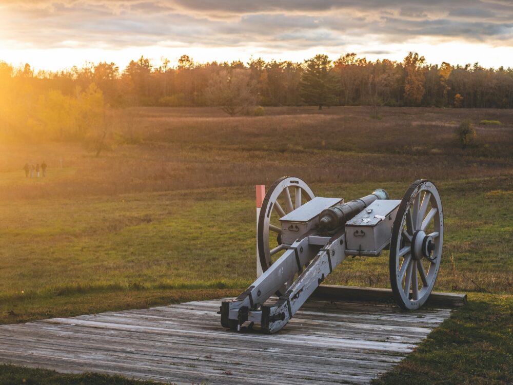 photo of canon light with dawn like light and fall tree is the background